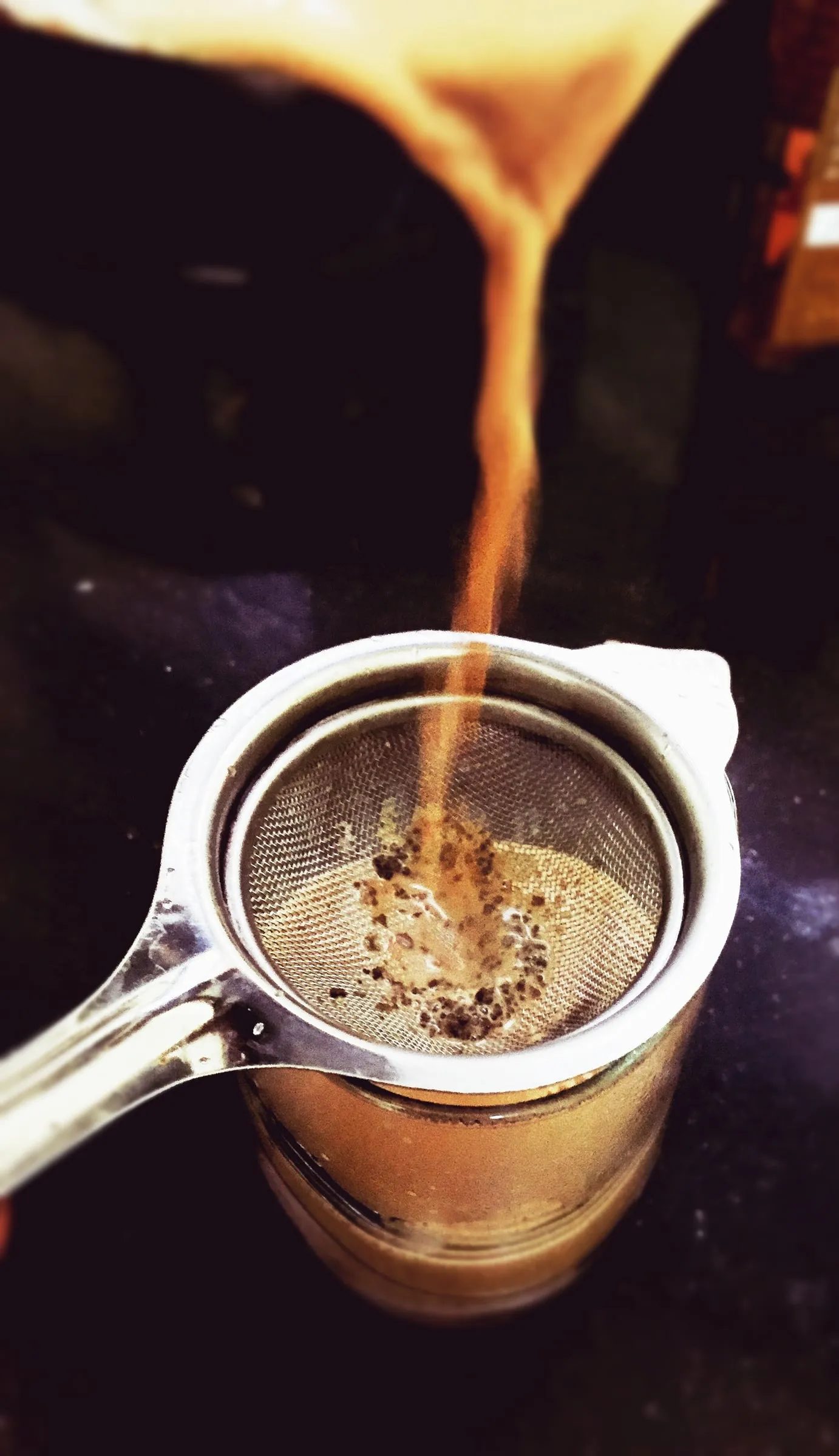 Cup of herbal tea with a tea strainer